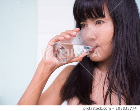 Woman Drinking Pure Ice Water Close Up,Lady Holding Water in Glass for Drink,Authentic Asian Woman Blac Hair Black Eyes and Skin Tan Asian Thailand, Slim Fit and Diet,Food for Good Health Concetp. Woman Drinking Pure Ice Water Close Up,Lady Holding Water in Glass for Drink,Authentic Asian Woman Blac Hair Black Eyes and Skin Tan Asian Thailand, Slim Fit and Diet,Food for Good Health Concetp. 105835774