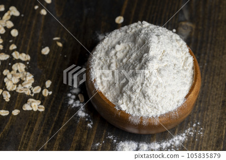 Wheat flour from a wooden bowl Wheat flour from a wooden bowl 105835879