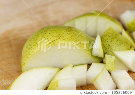 sliced green pear on a wooden board close-up 105836009