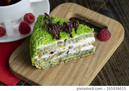 A piece of sweet green cake with berries A piece of sweet green cake with berries 105836015
