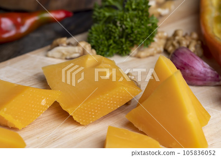 Sliced hard cheese made from milk 105836052