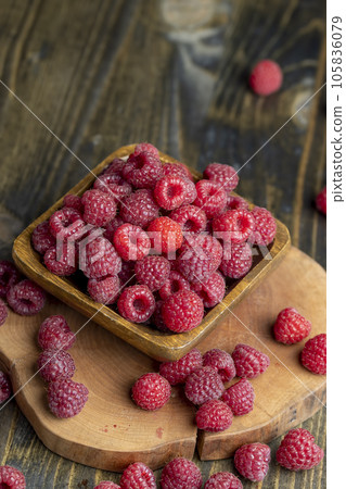 Ripe raspberries on a wooden board Ripe raspberries on a wooden board 105836079