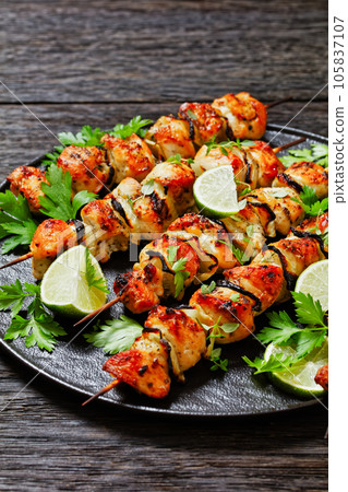 chicken souvlaki with parsley and lime on plate chicken souvlaki with parsley and lime on plate 105837107