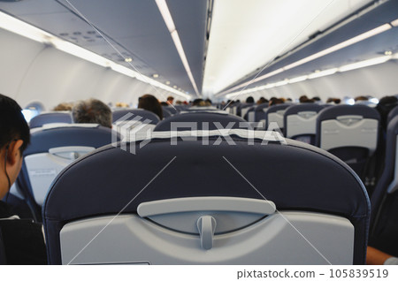 Interior of an airliner with traveler people 105839519