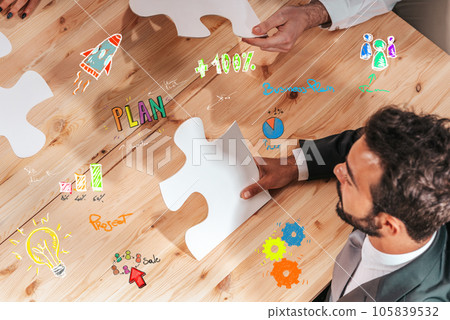 Businessmen working together to build a puzzle as teamwork, partnership and integration concept Businessmen working together to build a puzzle as teamwork, partnership and integration concept 105839532