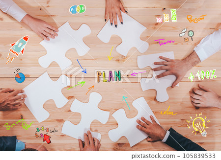 Businessmen working together to build a puzzle as teamwork, partnership and integration concept Businessmen working together to build a puzzle as teamwork, partnership and integration concept 105839533