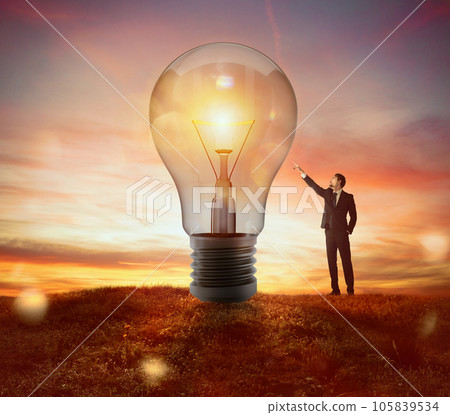 Businessman indicates a big light bulb as idea, resolution and creativity concept 105839534