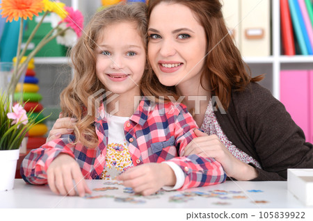 Cute little girl and her mother playing 105839922
