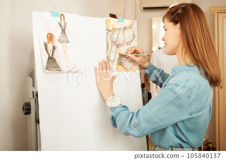 Portrait of beautiful attractive woman, red hair, smiling, happy. Professional seamstress, female strength, businesswoman. woman power Draws 105840137