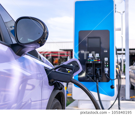 Electric cars parked for charging at power stations. 105840195