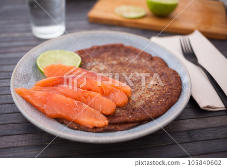 Salted salmon fillet with rye pancakes and lime Salted salmon fillet with rye pancakes and lime 105840602