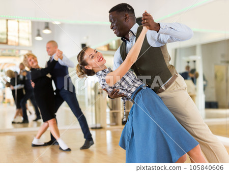 Woman with american man practising ballroom dancing Woman with american man practising ballroom dancing 105840606