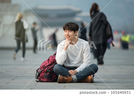 A young man traveling in Seoul, South Korea, with a backpack A young man traveling in Seoul, South Korea, with a backpack 105840931