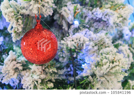 Christmas tree decorated with red ball on pine branches background 105841196