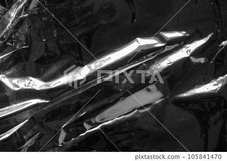 transparent plastic bag film wrap overlay texture on black background 105841470
