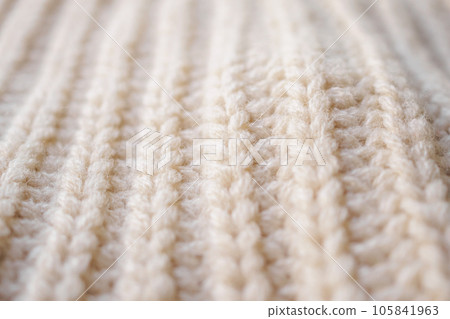 closeup beige knitted woolen fabric texture background closeup beige knitted woolen fabric texture background 105841963