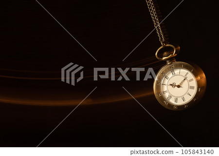 Hypnosis session. Vintage pocket watch with chain swinging over surface on dark background among faded clock faces, magic motion effect Hypnosis session. Vintage pocket watch with chain swinging over surface on dark background among faded clock faces, magic motion effect 105843140