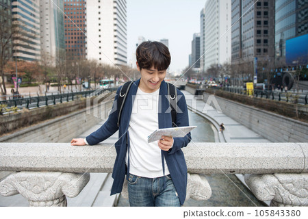 A young man traveling in Seoul, South Korea, with a backpack 105843380