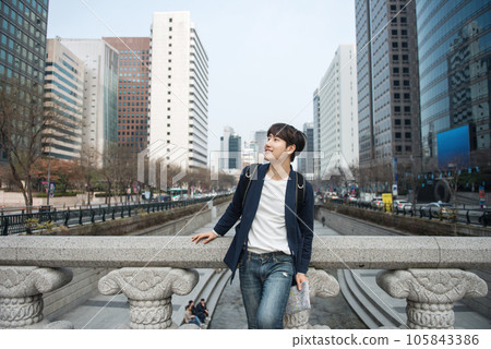 A young man traveling in Seoul, South Korea, with a backpack 105843386