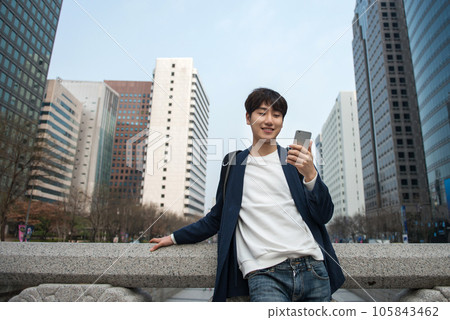 A young man traveling in Seoul, South Korea, with a backpack A young man traveling in Seoul, South Korea, with a backpack 105843462