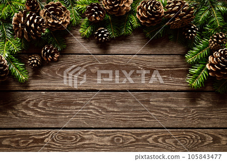 Christmas, Noel or New Year background with Christmas tree on wooden background, festive greeting card, holiday banner with copy space for a text, top down view 105843477