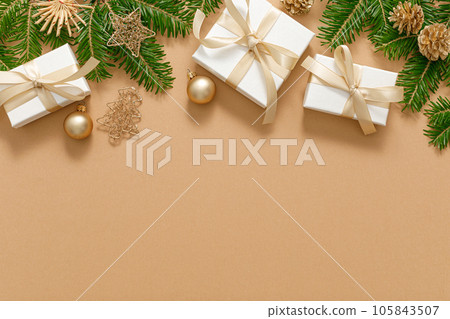 Christmas, Xmas, Noel or New Year background with winter festive Christmas holiday decoration, Christmas gift boxes and Christmas tree branches with copy space for a text of greeting card 105843507