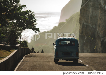 minivan driving on the road to the beach minivan driving on the road to the beach 105843947