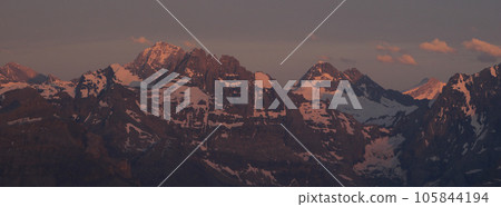 Gspaltenhorn and other mountains seen from Niesen Kulm in purple evening light. Gspaltenhorn and other mountains seen from Niesen Kulm in purple evening light. 105844194