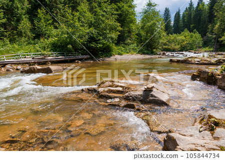 Mountain river in the forest among the rocks Mountain river in the forest among the rocks 105844734