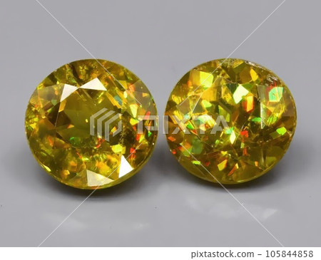 Natural green sphene gemstone isolated on white background 105844858