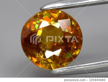 Natural green yellow sphene gemstone isolated on white background Natural green yellow sphene gemstone isolated on white background 105844860