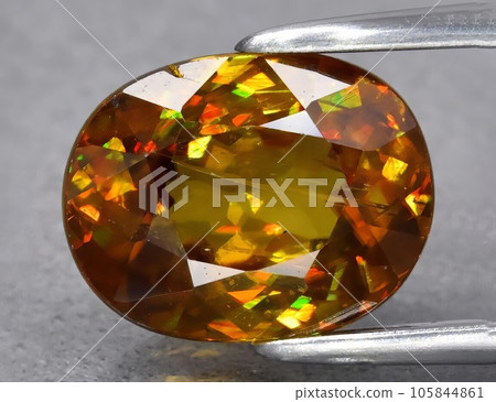 Natural green yellow sphene gemstone isolated on white background Natural green yellow sphene gemstone isolated on white background 105844861