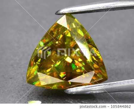 Natural green yellow sphene gemstone isolated on white background 105844862