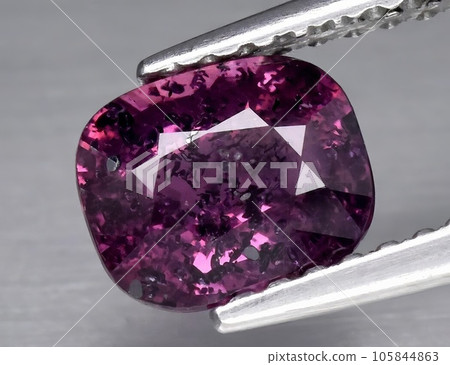 Natural gemstone purple sapphire on gray background 105844863