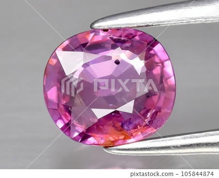 Natural gemstone purple sapphire on gray background Natural gemstone purple sapphire on gray background 105844874