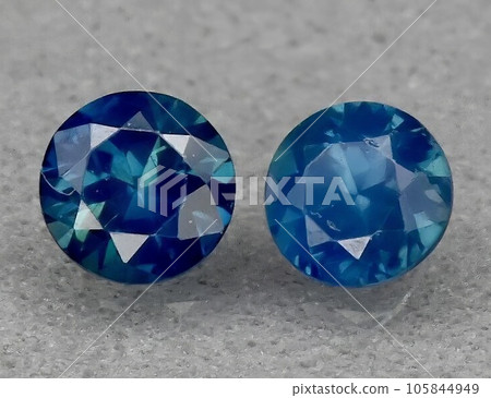 Natural gemstone green blue sapphire on gray background Natural gemstone green blue sapphire on gray background 105844949