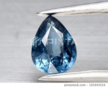 Natural gemstone blue sapphire on gray background 105845016