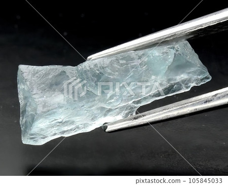 Natural blue aquamarine gem on gray background Natural blue aquamarine gem on gray background 105845033