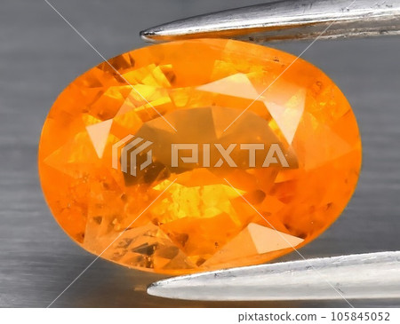 Natural gemstone yellow sapphire on gray background Natural gemstone yellow sapphire on gray background 105845052