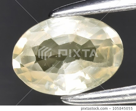 Natural gemstone yellow sapphire on gray background Natural gemstone yellow sapphire on gray background 105845055