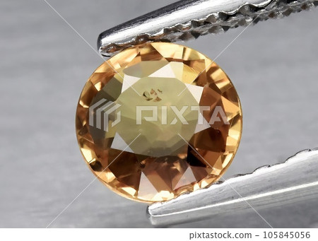 Natural gemstone yellow sapphire on gray background Natural gemstone yellow sapphire on gray background 105845056