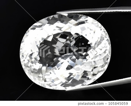 Natural gemstone white quartz on black background Natural gemstone white quartz on black background 105845059