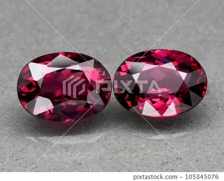 Natural gemstone red rhodolite garnet on gray background Natural gemstone red rhodolite garnet on gray background 105845076