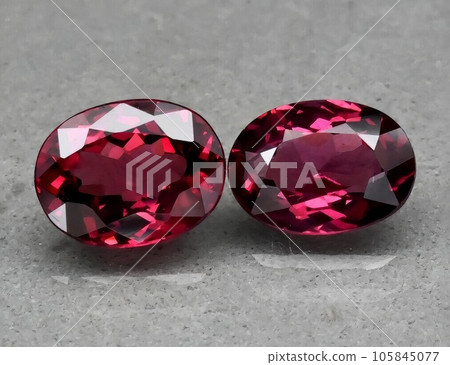 Natural gemstone red rhodolite garnet on gray background Natural gemstone red rhodolite garnet on gray background 105845077