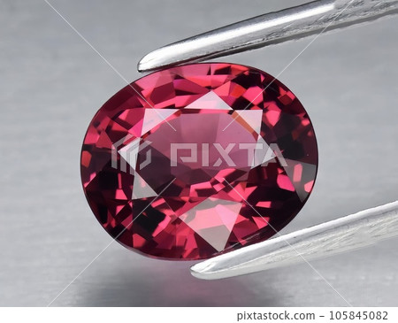 Natural gemstone red rhodolite garnet on gray background Natural gemstone red rhodolite garnet on gray background 105845082