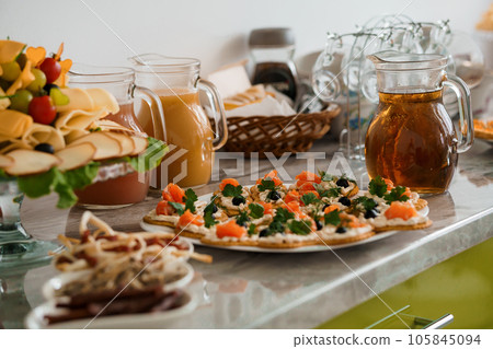 Canapes with salmon, cream cheese and greens. Festive buffet Canapes with salmon, cream cheese and greens. Festive buffet 105845094