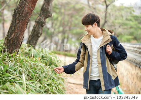 Young male college student traveling with a backpack in Korea Young male college student traveling with a backpack in Korea 105845349