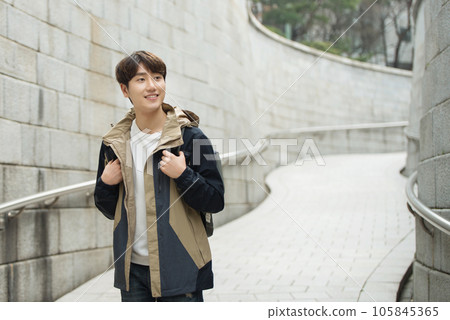 Young male college student traveling with a backpack in Korea 105845365
