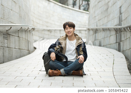 Young male college student traveling with a backpack in Korea 105845422