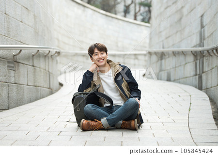 Young male college student traveling with a backpack in Korea 105845424